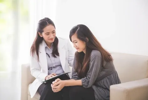 A few women looking at a tablet Description automatically generated with medium confidence